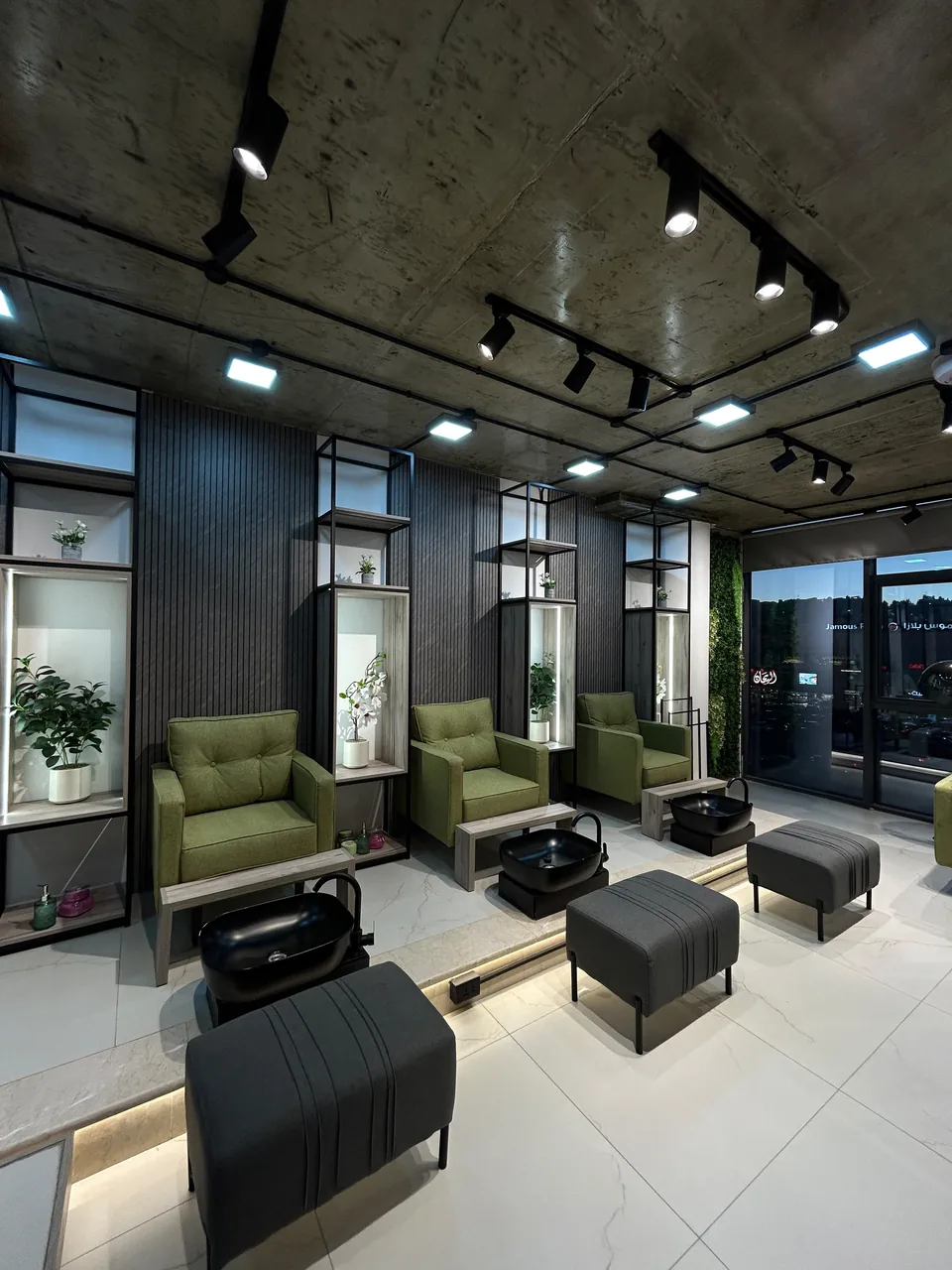 Green pedicure seating and plants inside The Beauty Spot by Samah